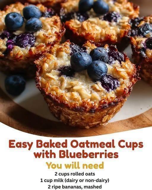 A top-down view of freshly made baked oatmeal cups loaded with blueberries and cinnamon sitting on a wire cooling rack