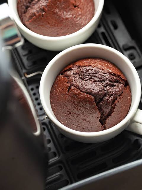 Moist Air Fryer Chocolate Cake topped with chocolate frosting and chocolate shavings